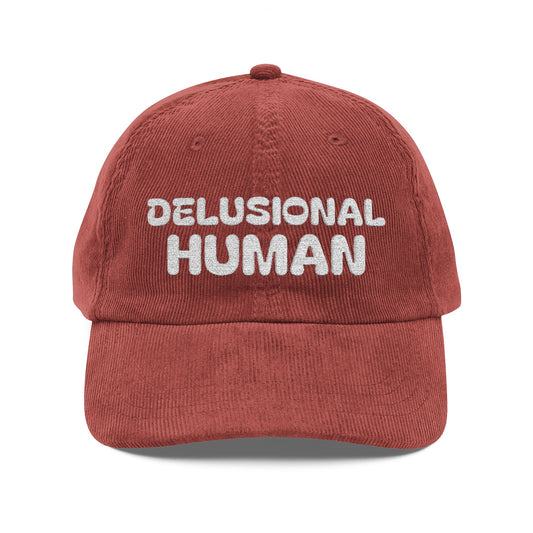 Red cap with 'DELUSIONAL HUMAN' text on a white background