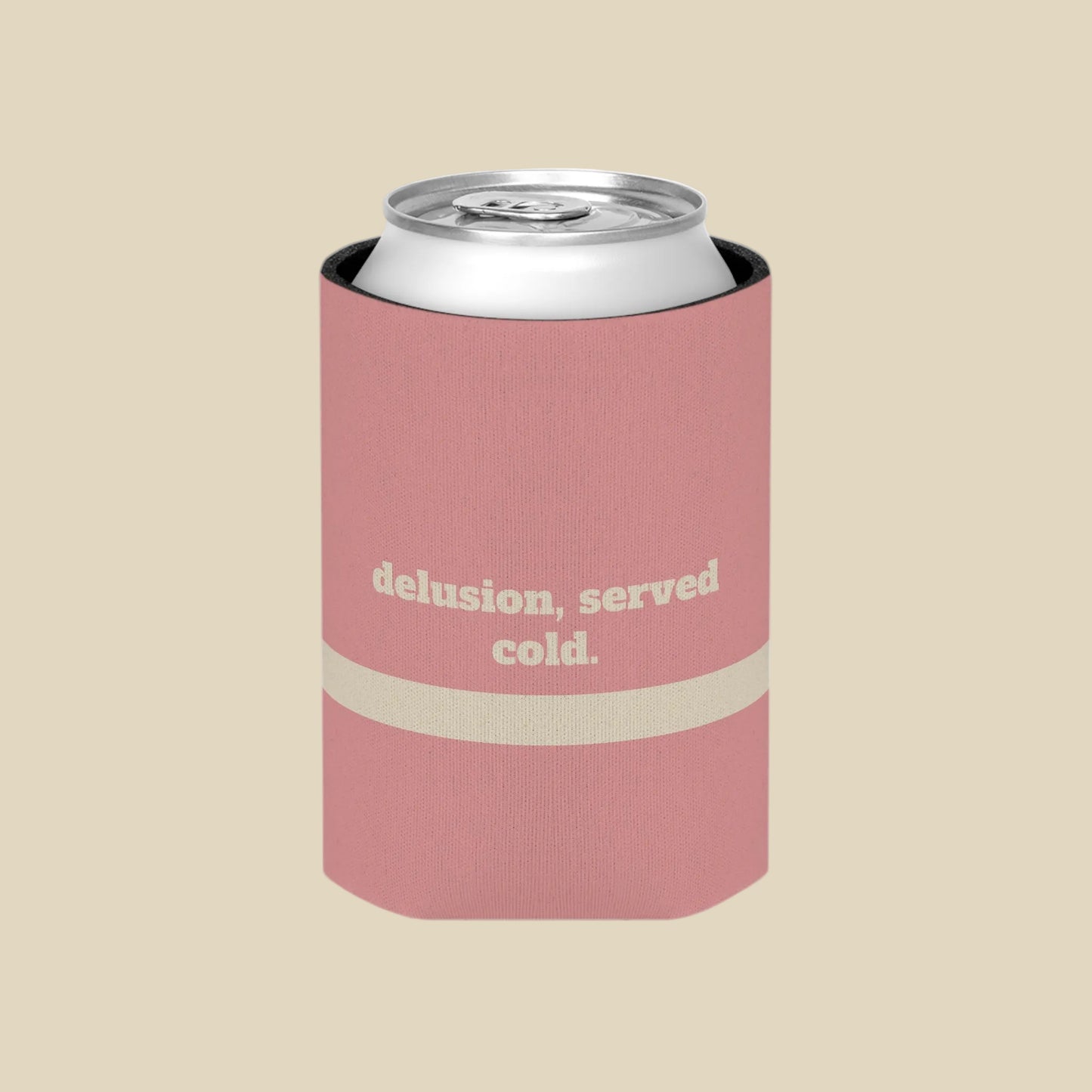 A pink can cooler sleeve with a silver aluminum can inside, featuring the text 'delusion, served cold.' in beige on the front, set against a plain white background.
