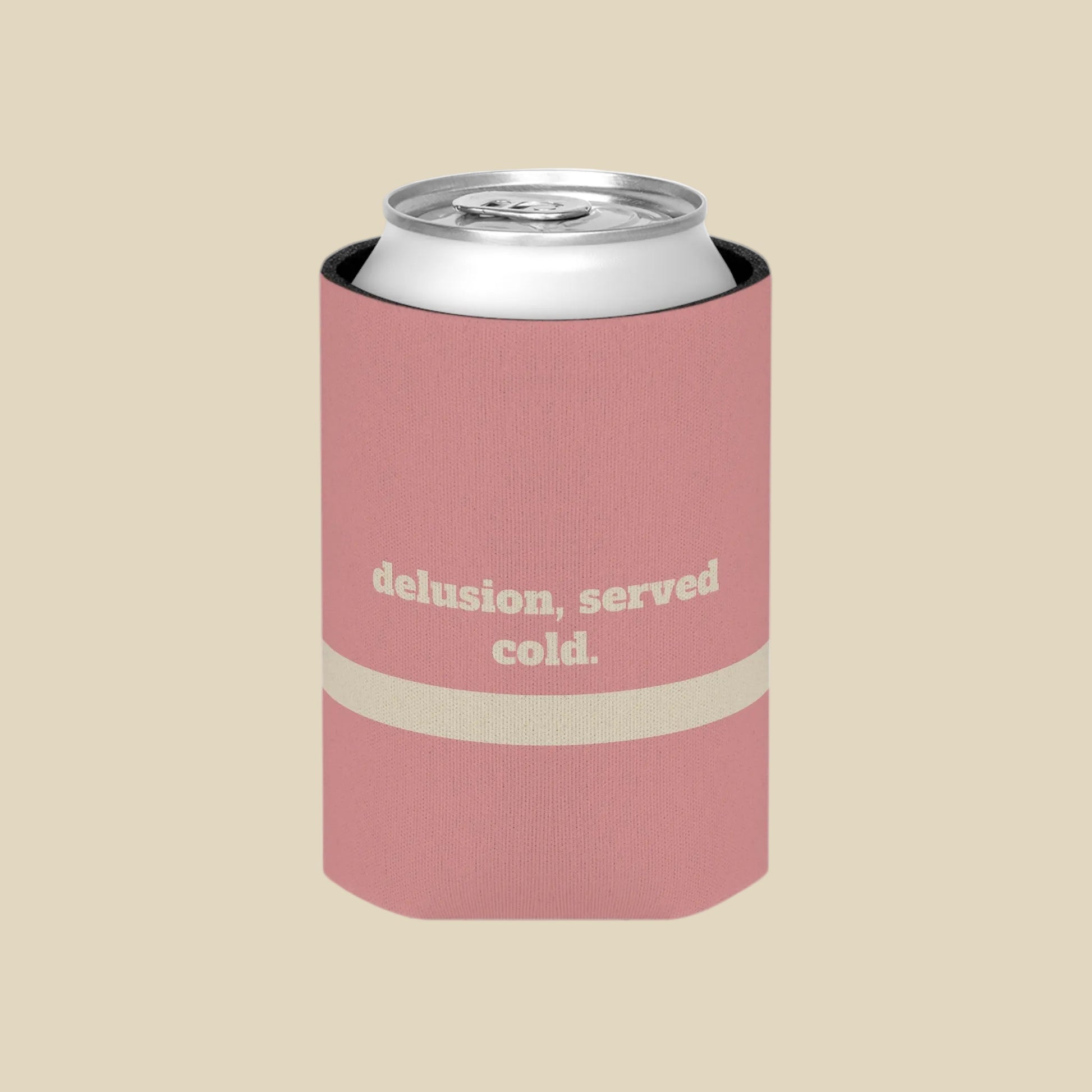 A pink can cooler sleeve with a silver aluminum can inside, featuring the text 'delusion, served cold.' in beige on the front, set against a plain white background.