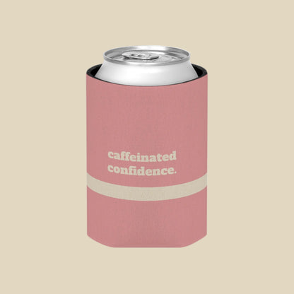 A pink can cooler sleeve holding a silver aluminum can, featuring the text 'caffeinated confidence.' in white on the front, set against a plain white background.